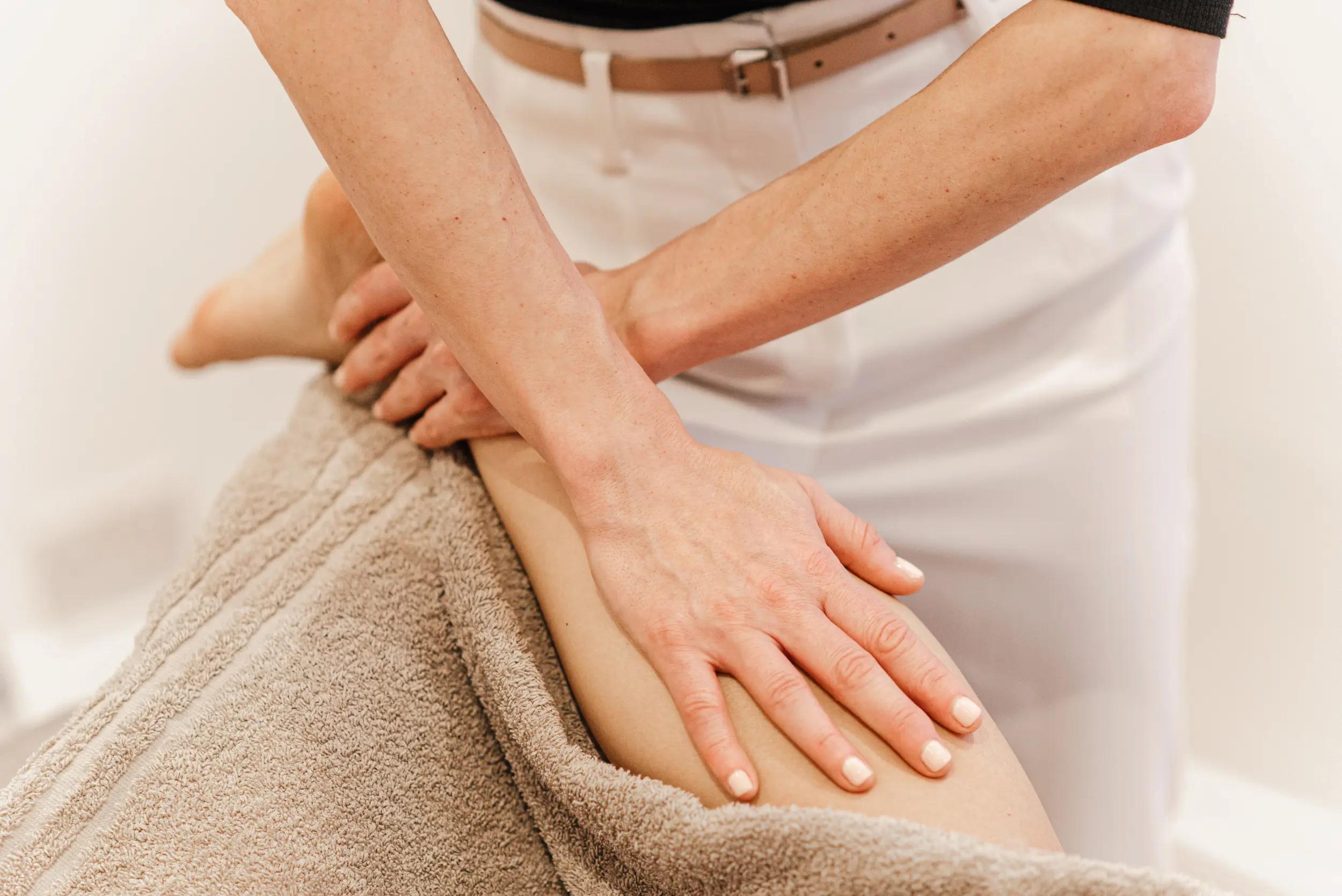 Marta massaging the calf muscle of a client gently