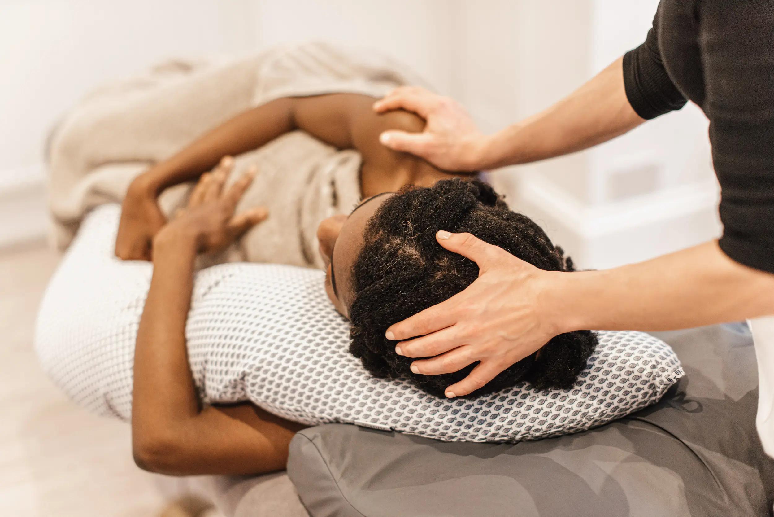 Marta massaging the head of a client - relaxing and comforting