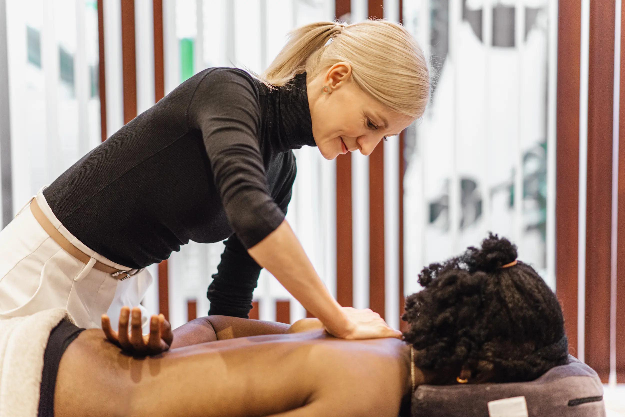 Marta massaging a clinet during a sports massage - massage for athletes